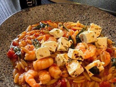 Orzo pasta with prawns, tomato and marinated feta, drizzled with olive oil
